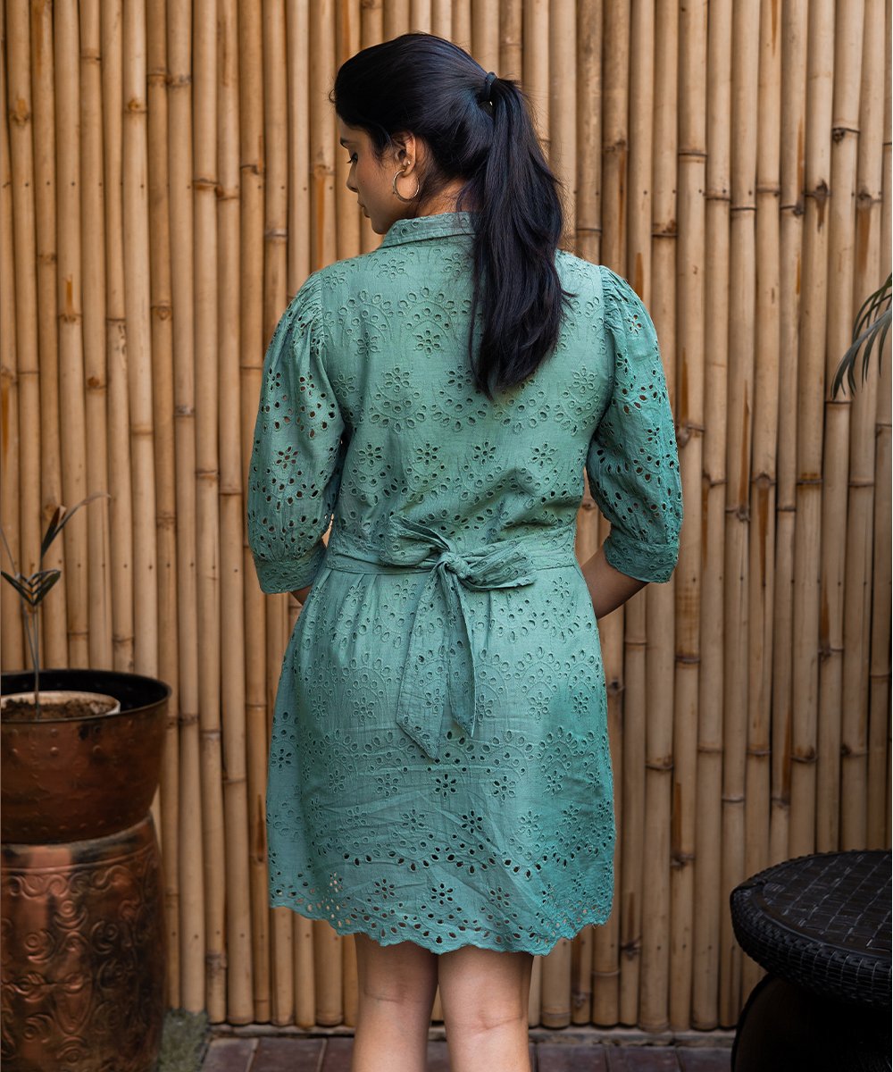 Back view of green eyelet shirt dress showing waist tie-belt and embroidered detailing