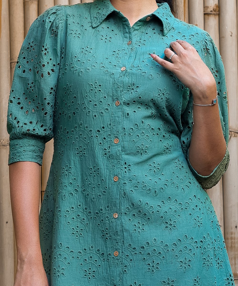 Close view of green eyelet shirt dress showing detailed embroidery, collar, and puff sleeves