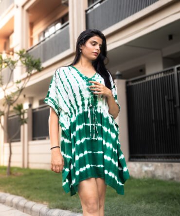 Model wearing a green and white tie-dye kaftan dress with drawstring waist and V-neckline – front view