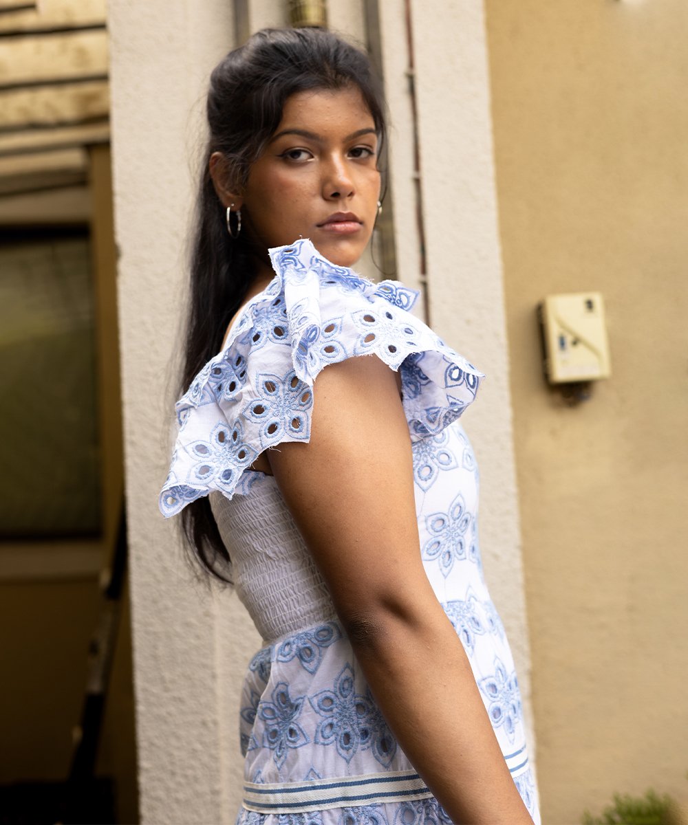Side view of blue and white cotton eyelet tiered dress showing tiered layers