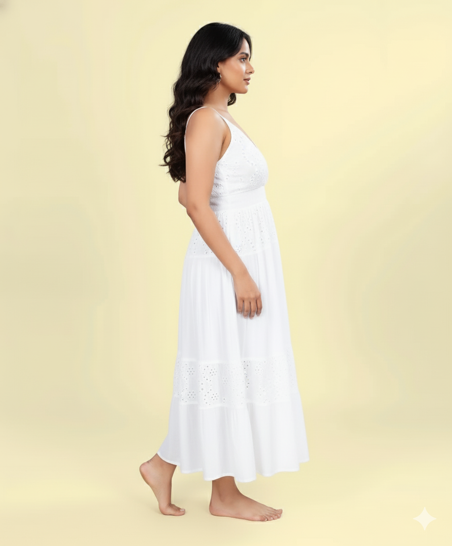Side view of white cotton eyelet sleeveless maxi dress featuring V-neckline and tiered design.