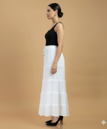 Side view of white cotton fringe tier maxi skirt showing flowy silhouette and textured fringe detailing