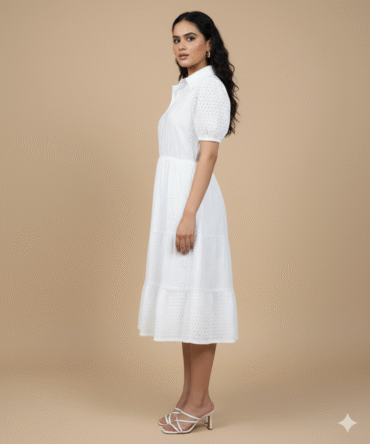 Side view of collared cotton eyelet dress showing flared silhouette