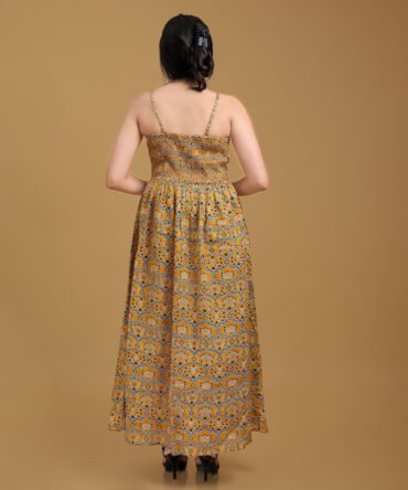 Back view of mustard printed strappy maxi dress with adjustable shoulder straps and flowy cotton silhouette