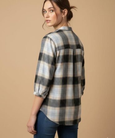 Back view of a woman wearing a beige and black checkered shirt showing the relaxed fit and check pattern across the back.