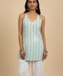 Model wearing green printed halter cotton kurti with tie-back design and white pants – boho chic summer outfit.