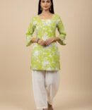 Model wearing a green paisley printed kurti with bell sleeves and tie-back detail, front view.