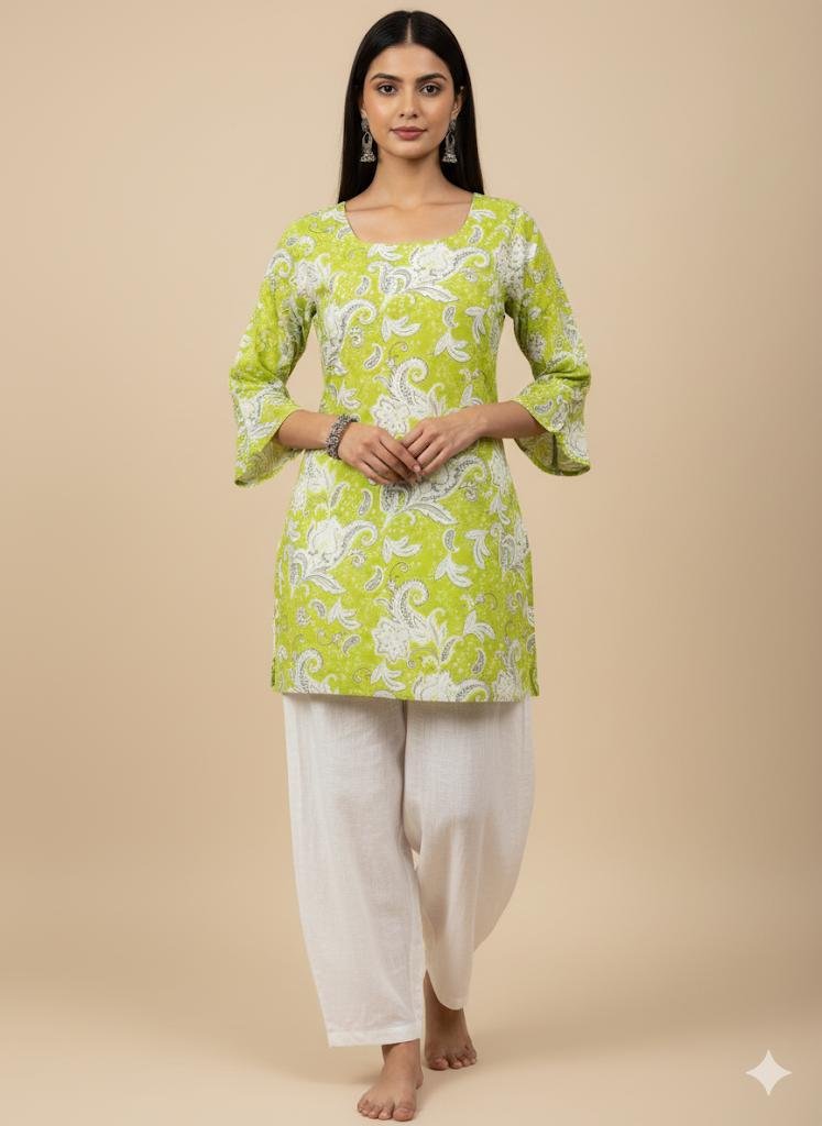 Model wearing a green paisley printed kurti with bell sleeves and tie-back detail, front view.
