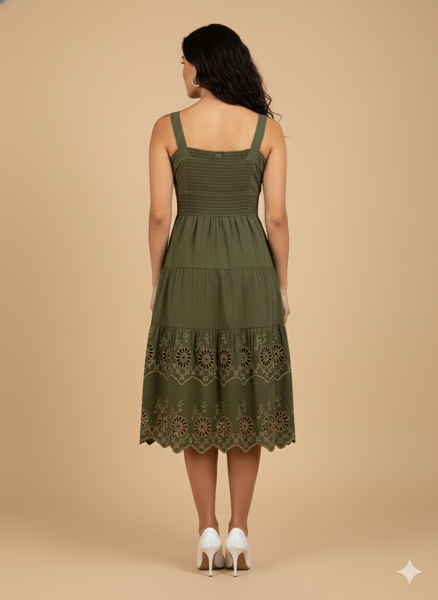 Back view of olive green cotton midi dress with tan eyelet embroidery and adjustable strap design.