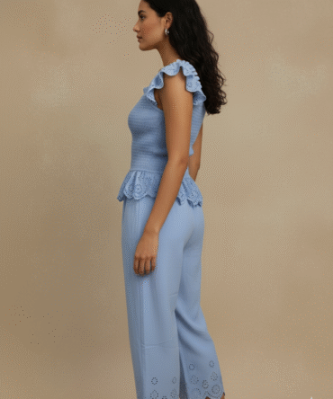 side view of sky blue cotton eyelet co-ord set with ruffle sleeves and scalloped hem pants — minimal summer outfit, cottagecore Pinterest vibe, chic resort wear