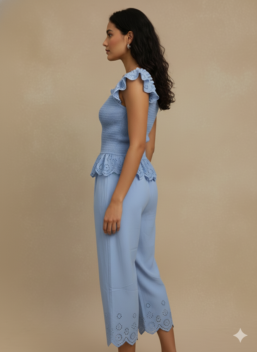 side view of sky blue cotton eyelet co-ord set with ruffle sleeves and scalloped hem pants — minimal summer outfit, cottagecore Pinterest vibe, chic resort wear