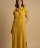Woman wearing a yellow cotton double gauze button-down dress styled for fall fashion, featuring short sleeves, pockets, and a minimal neutral chic look.
