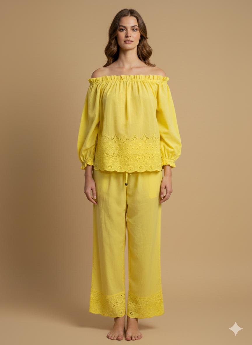 Model wearing a yellow cotton off shoulder co-ord set, with eyelet detailing