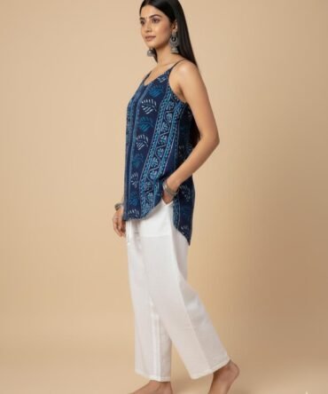 Side view of model wearing blue batik print cotton kurti, featuring strappy shoulders and relaxed fit – boho chic summer outfit.