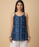 Model wearing blue batik print strappy cotton kurti with white pants — boho chic summer top in handprinted cotton