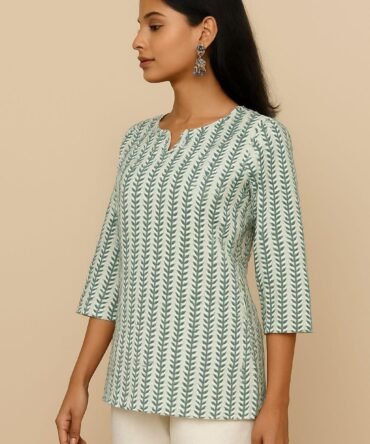 Model in side profile wearing a green printed cotton kurti – relaxed fit with earthy printed details, perfect for brunch or casual outings.
