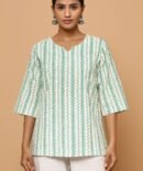 Model wearing a green printed cotton kurti with a notched neckline and ¾ sleeves – front view in a fresh, boho-chic vibe.